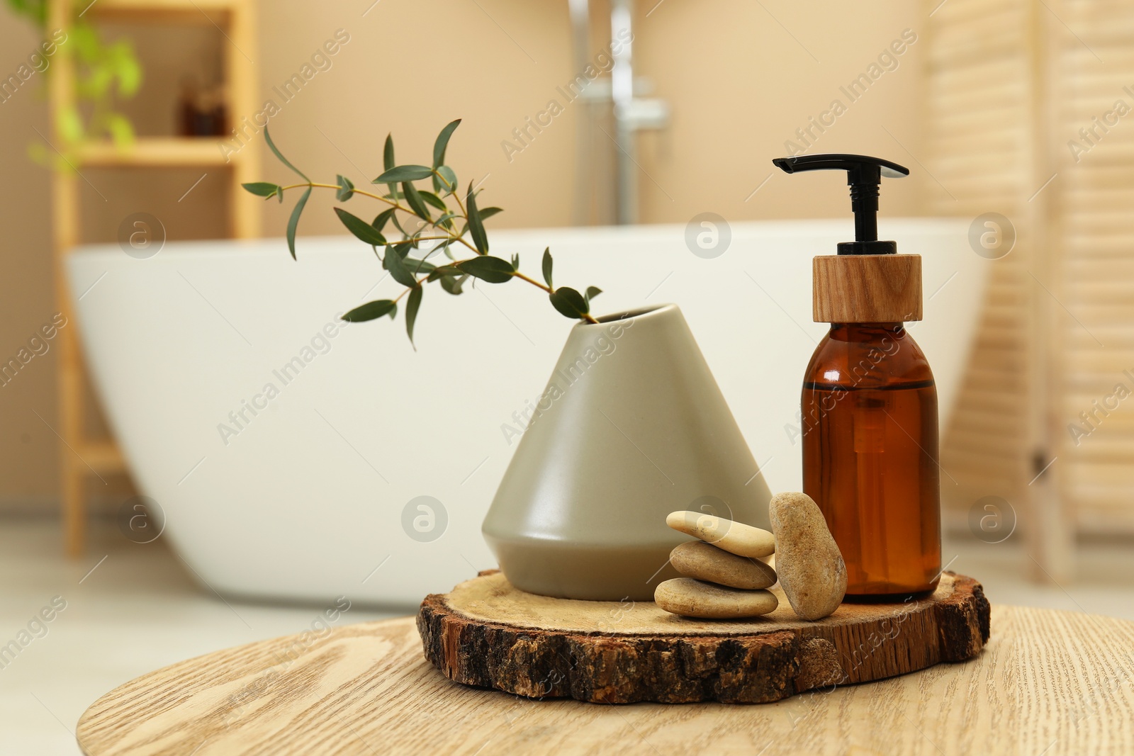 Photo of Personal care product, stones and vase on table in bathroom