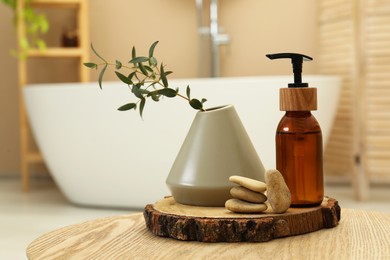 Personal care product, stones and vase on table in bathroom