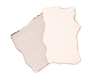 Photo of Pieces of old paper with dark burnt borders isolated on white, top view