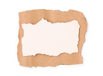 Photo of Pieces of old paper with dark burnt borders isolated on white, top view