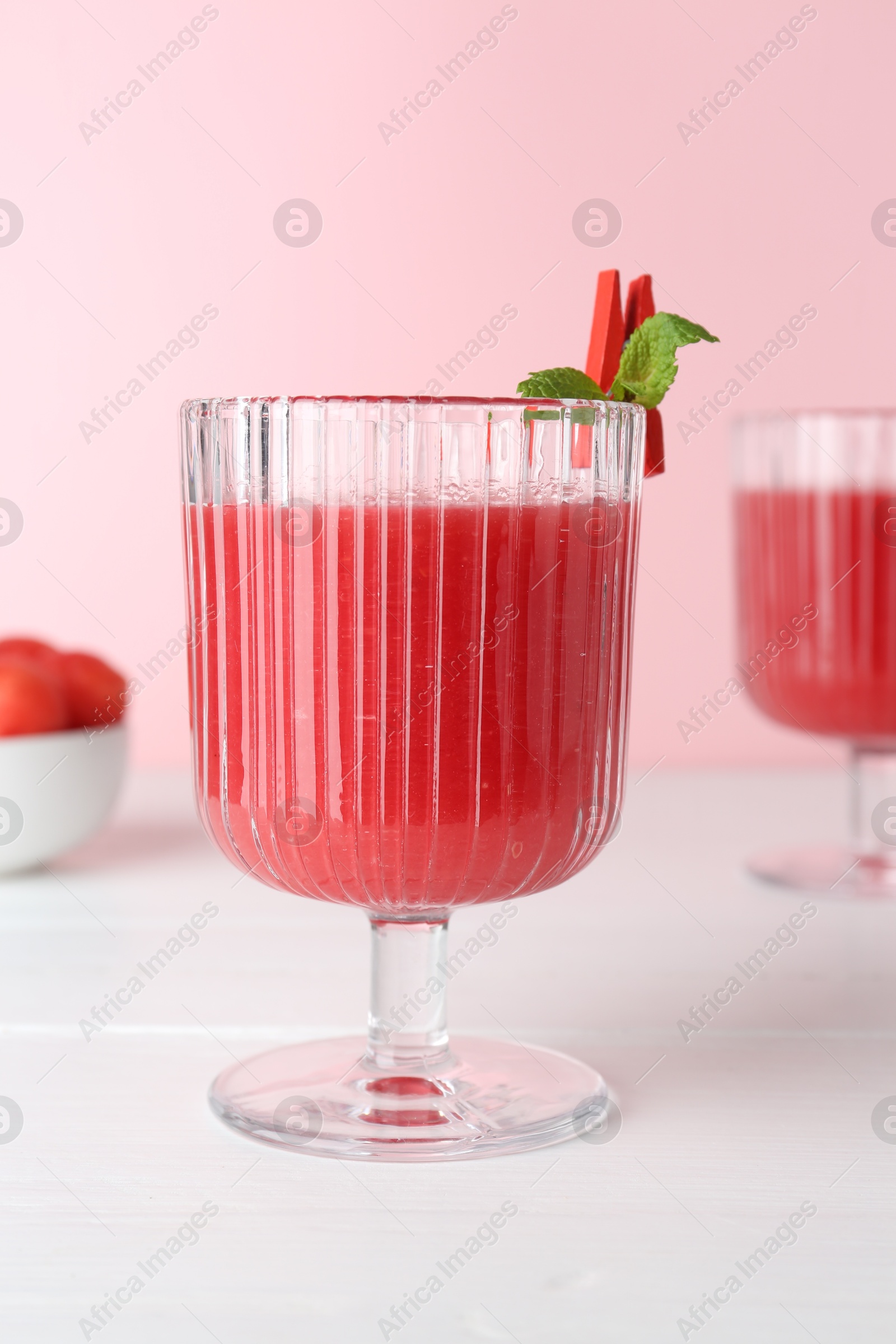 Photo of Tasty watermelon drink in glasses on white wooden table