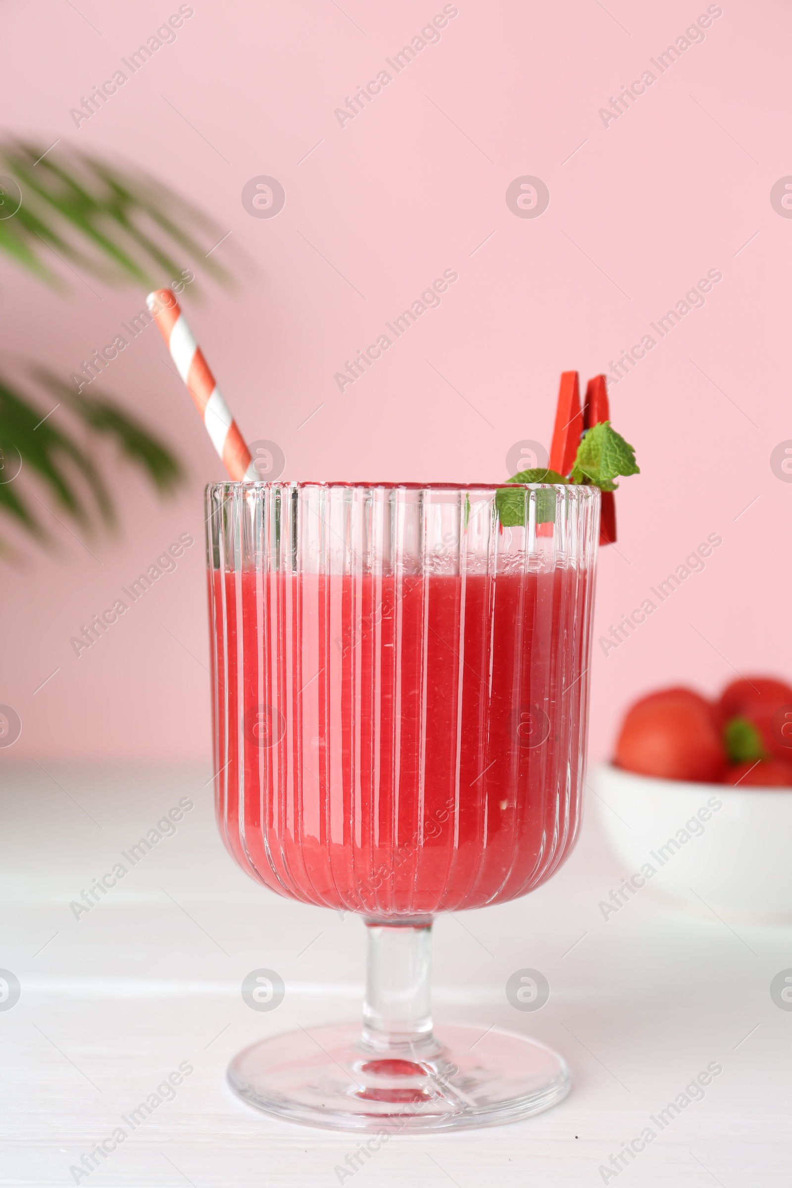 Photo of Tasty watermelon drink in glass and mint on white wooden table