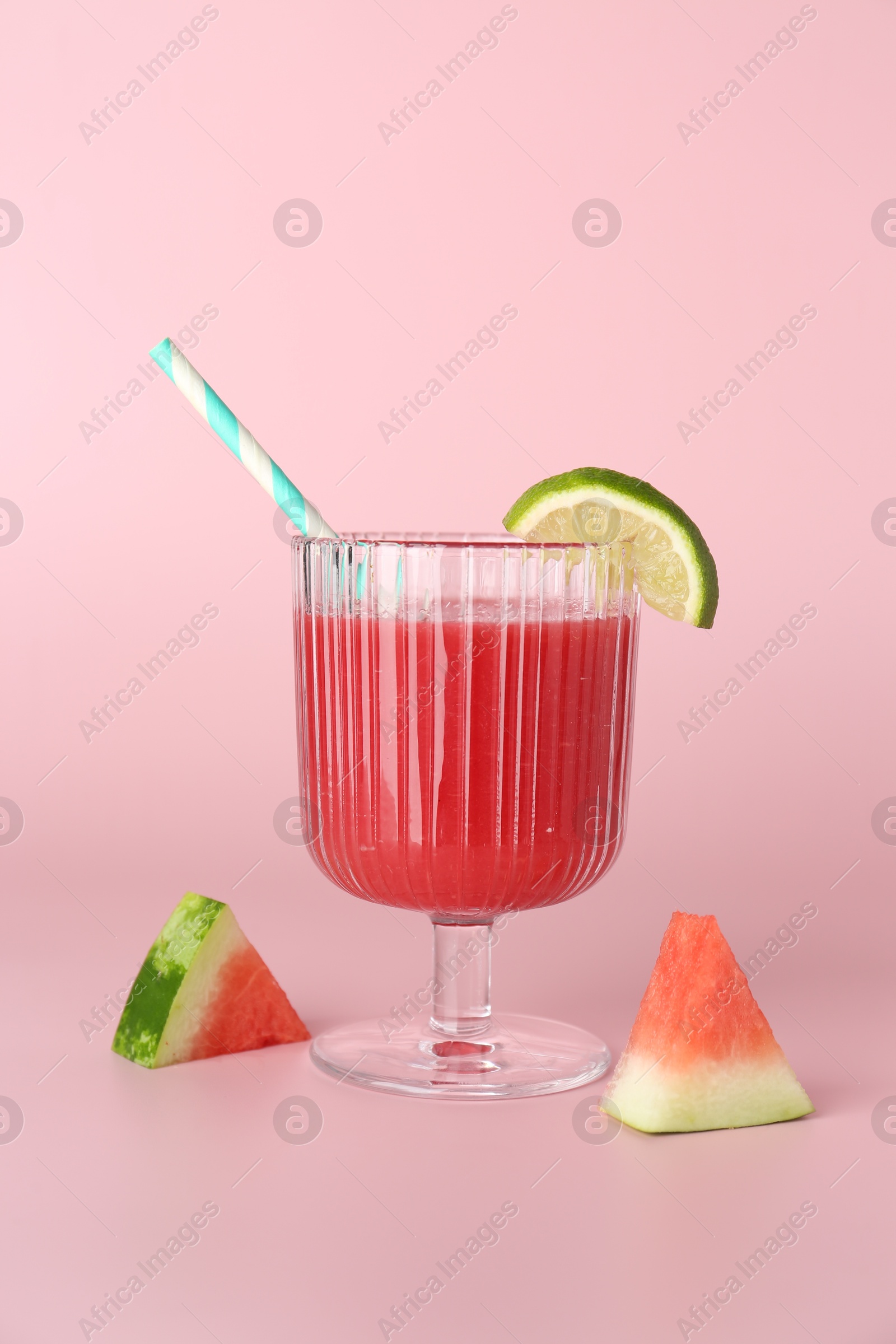 Photo of Tasty watermelon drink in glass and fresh fruits on pink background