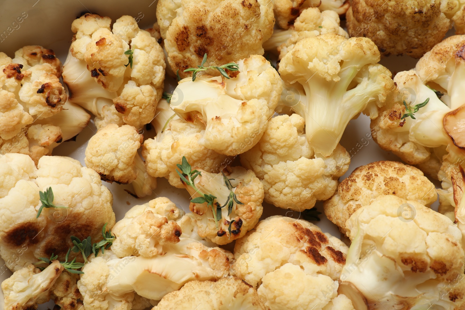 Photo of Tasty baked cauliflower in baking dish, top view