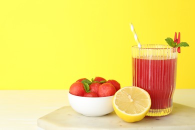 Photo of Tasty watermelon drink in glass and fresh fruits on white table. Space for text