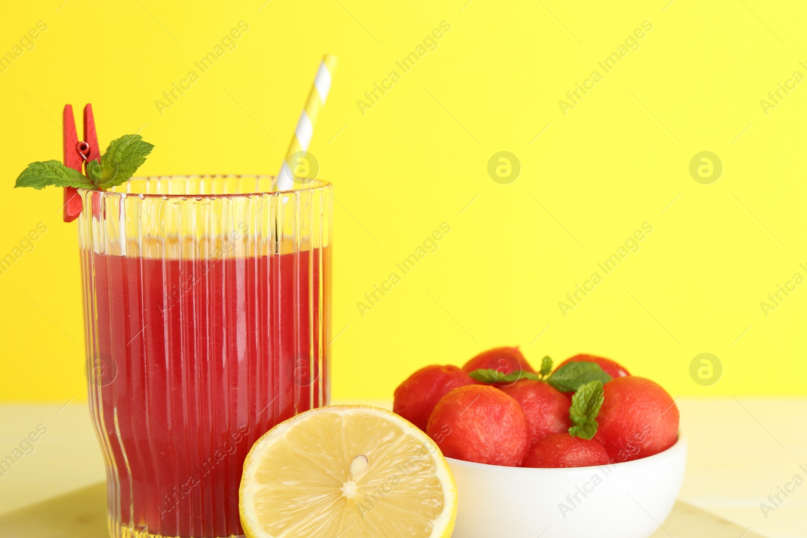 Photo of Tasty watermelon drink in glass and fresh fruits on table, closeup