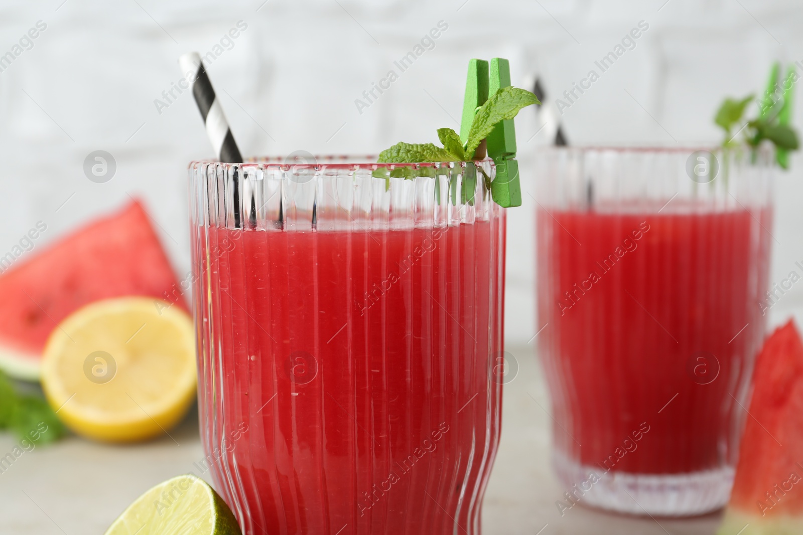 Photo of Delicious watermelon drink in glasses on table, closeup