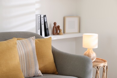 Photo of Different soft pillows on gray sofa in living room