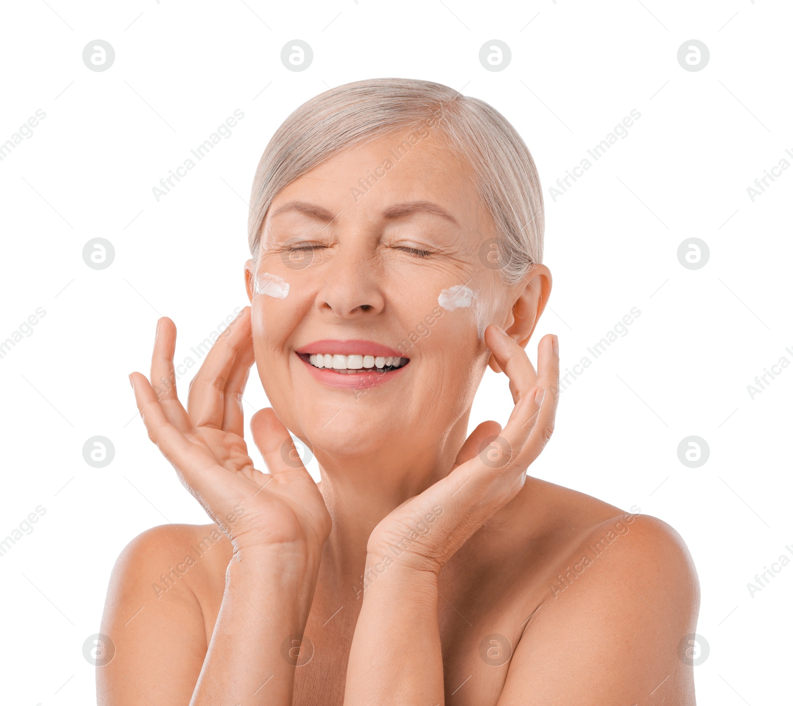 Photo of Senior woman with face cream on white background