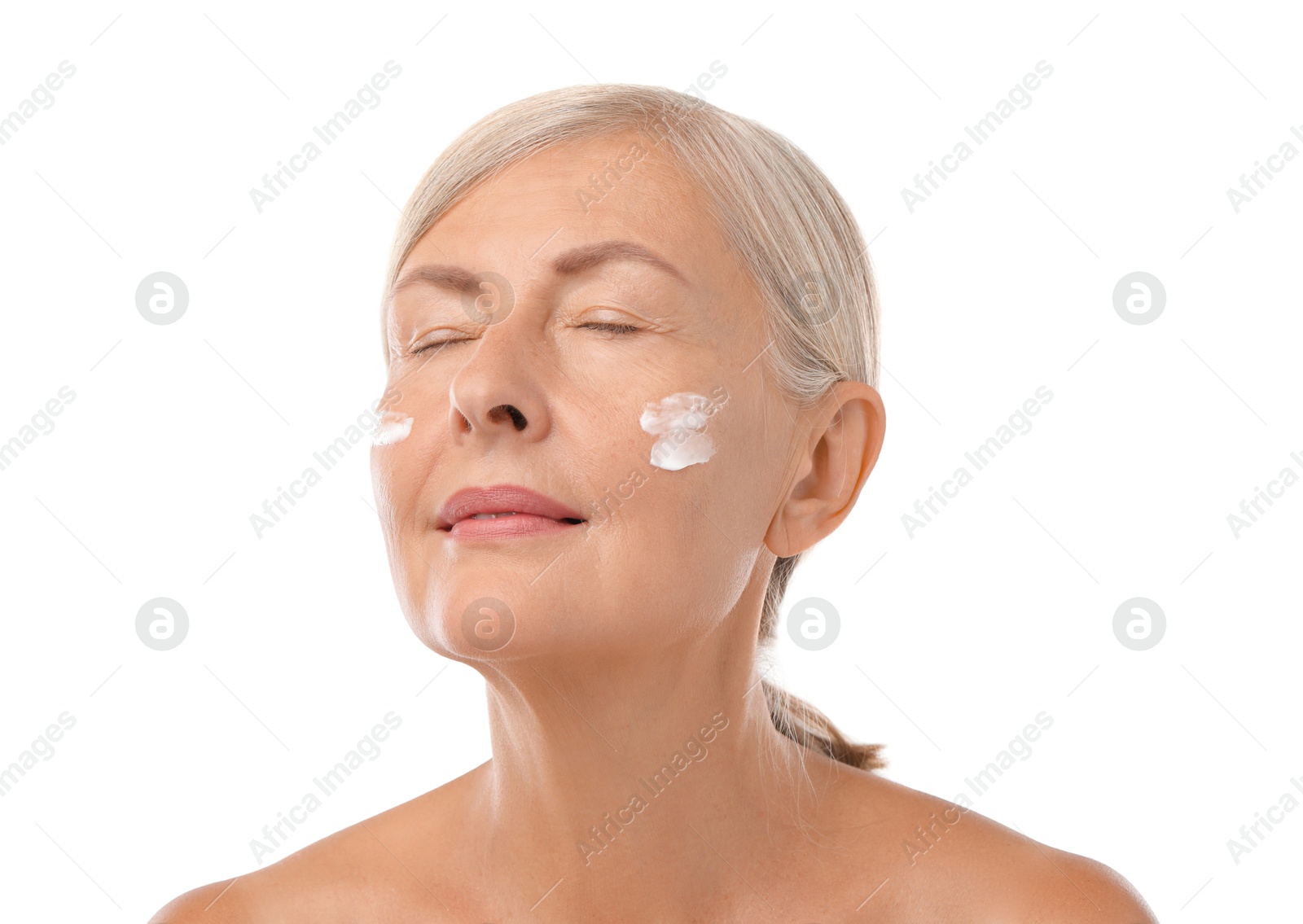 Photo of Senior woman with face cream on white background