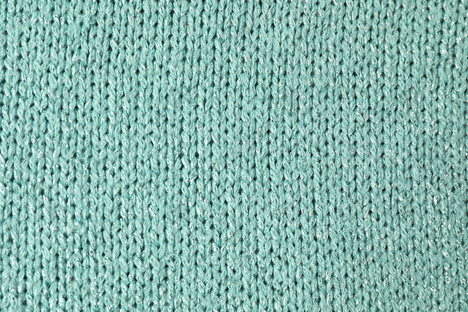 Photo of Texture of turquoise knitted fabric as background, top view