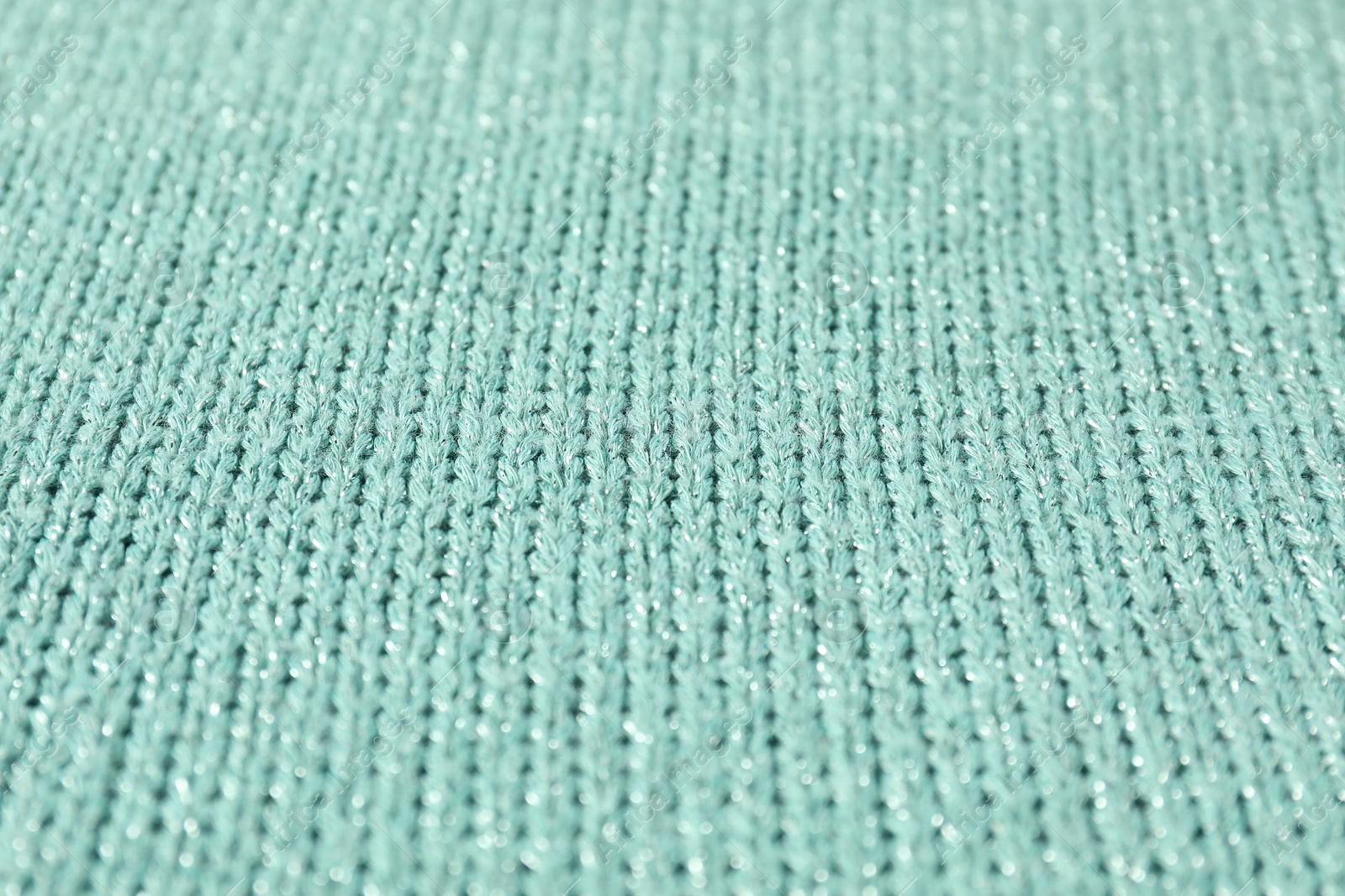 Photo of Texture of turquoise knitted fabric as background, closeup