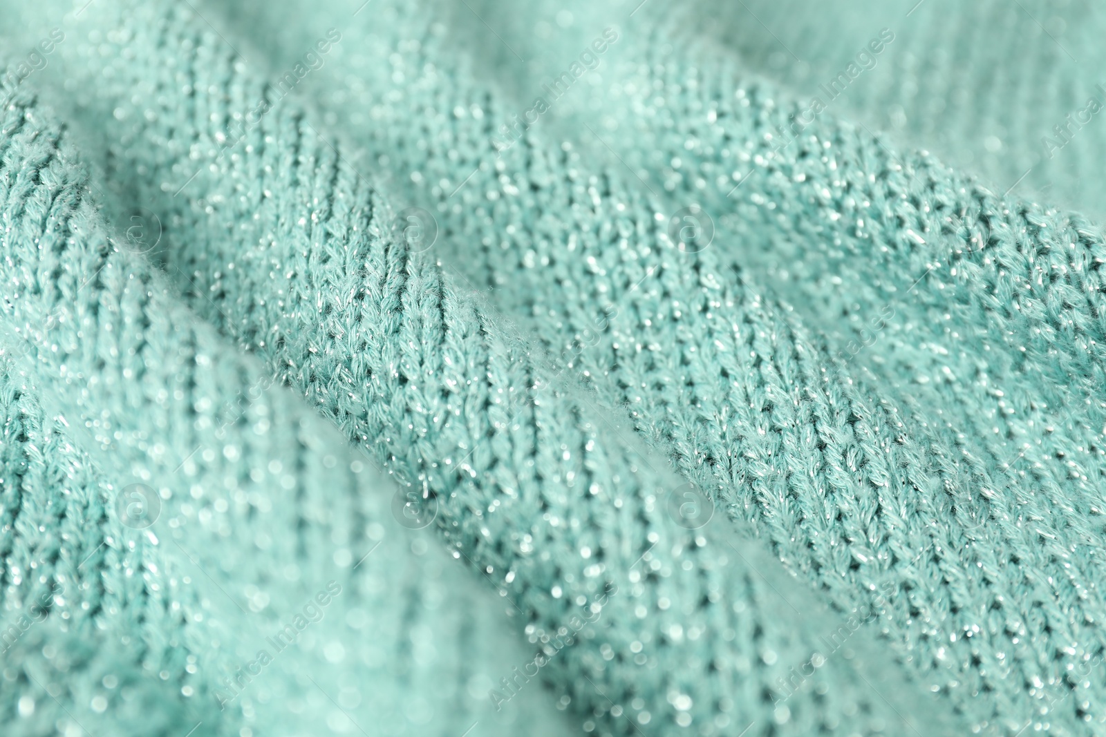 Photo of Texture of turquoise knitted fabric as background, closeup