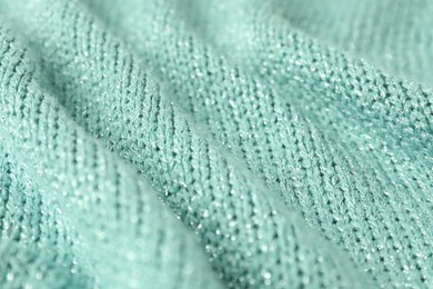 Texture of turquoise knitted fabric as background, closeup