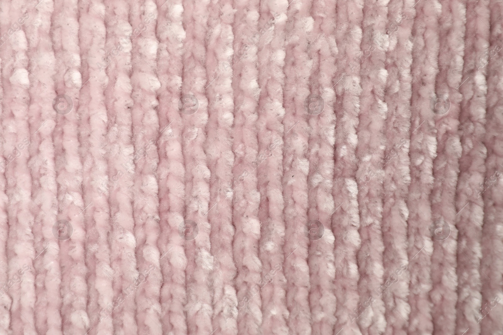 Photo of Texture of pink knitted fabric as background, top view