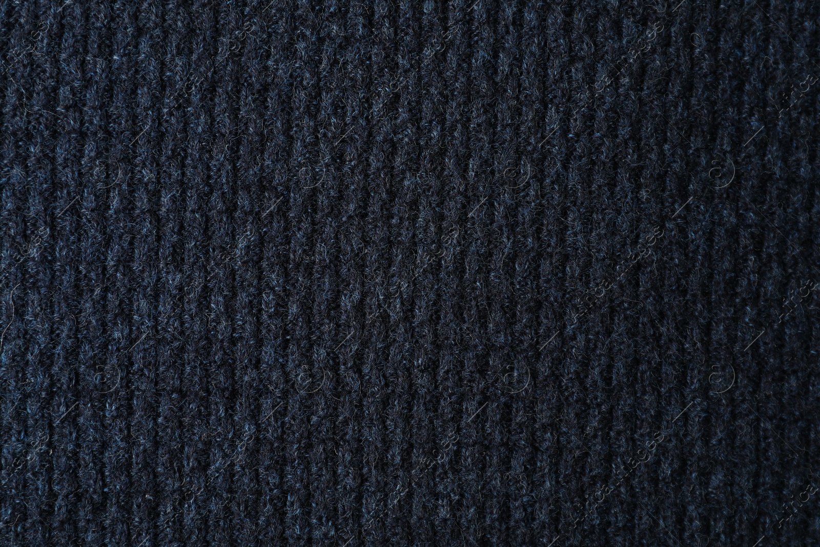 Photo of Texture of dark blue knitted fabric as background, top view