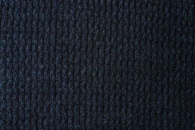 Texture of dark blue knitted fabric as background, top view