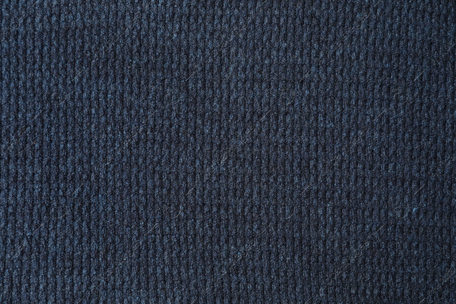 Photo of Texture of dark blue knitted fabric as background, top view