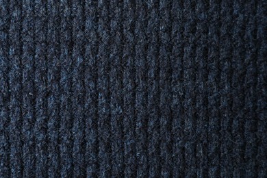 Texture of dark blue knitted fabric as background, top view