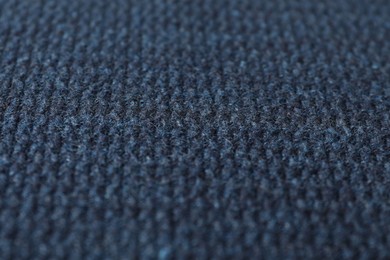 Photo of Texture of dark blue knitted fabric as background, closeup