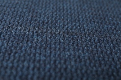 Photo of Texture of dark blue knitted fabric as background, closeup