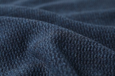 Texture of dark blue knitted fabric as background, closeup