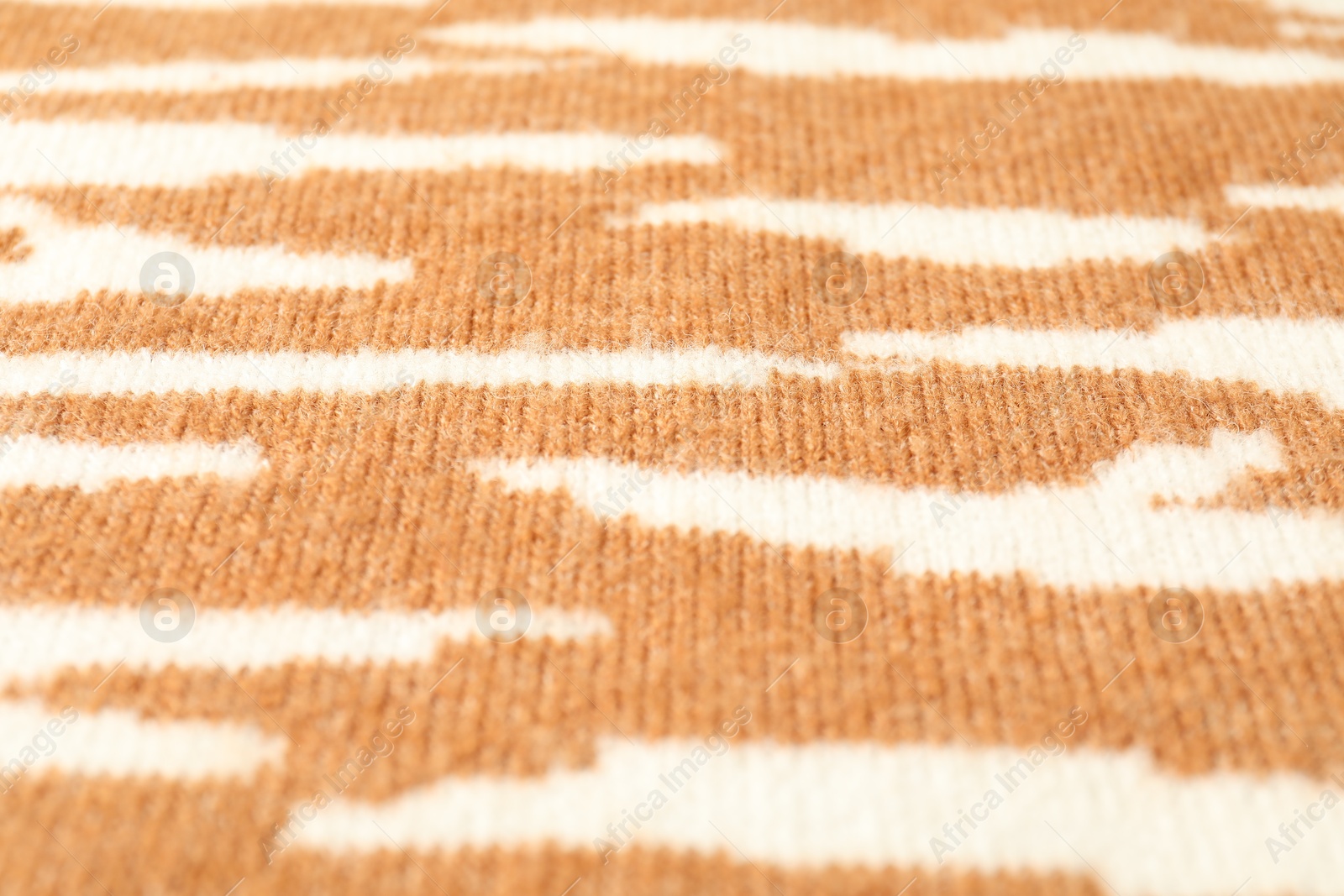 Photo of Texture of bright knitted fabric with pattern as background, closeup