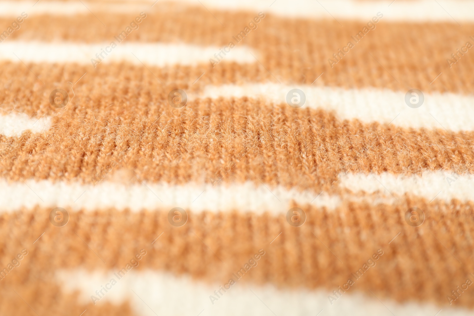 Photo of Texture of bright knitted fabric with pattern as background, closeup