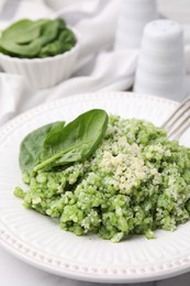 Photo of Tasty spinach risotto served on table, closeup