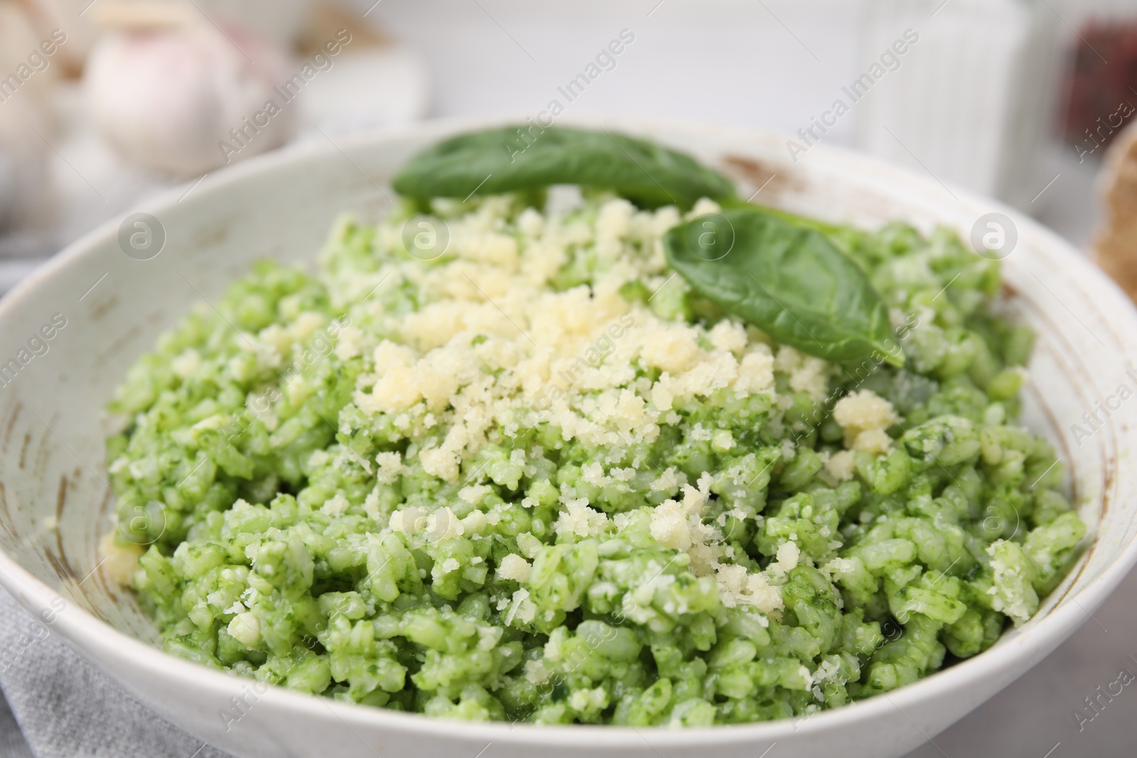 Photo of Tasty spinach risotto served on table, closeup