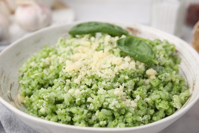 Photo of Tasty spinach risotto served on table, closeup