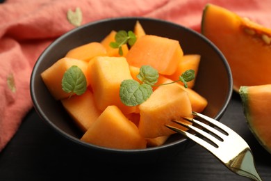 Photo of Pieces of ripe Cantaloupe melon in bowl on table, closeup