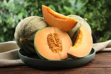 Photo of Fresh ripe Cantaloupe melons on wooden table, closeup