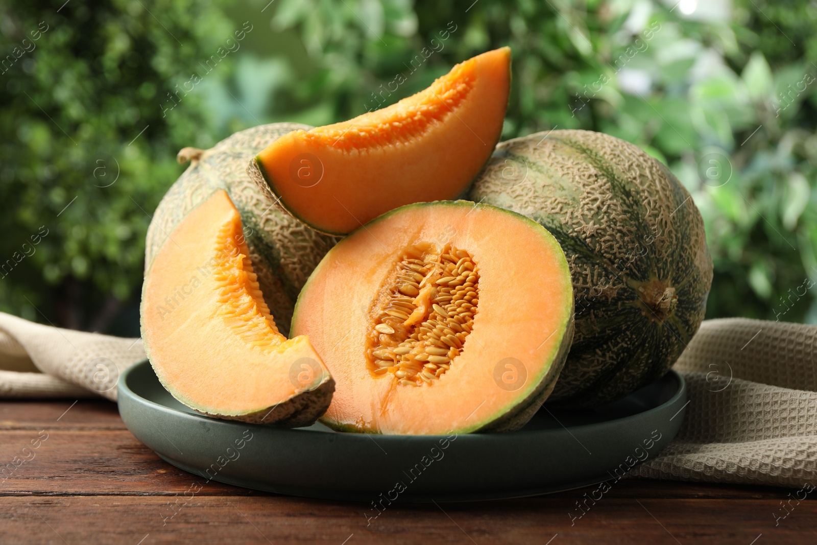 Photo of Fresh ripe Cantaloupe melons on wooden table, closeup