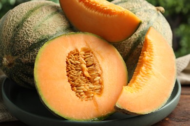 Photo of Fresh ripe Cantaloupe melons on table, closeup