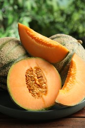 Fresh ripe Cantaloupe melons on wooden table, closeup