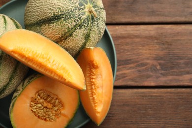 Fresh ripe Cantaloupe melons on wooden table, top view. Space for text