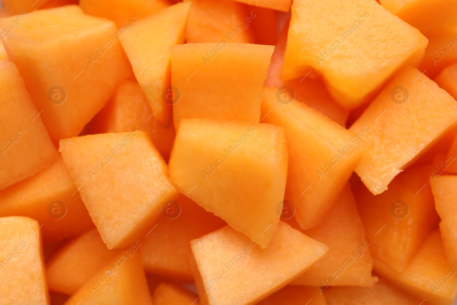 Photo of Pieces of Cantaloupe melon as background, top view