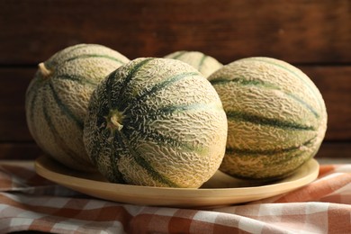 Photo of Tasty ripe Cantaloupe melons on table, closeup