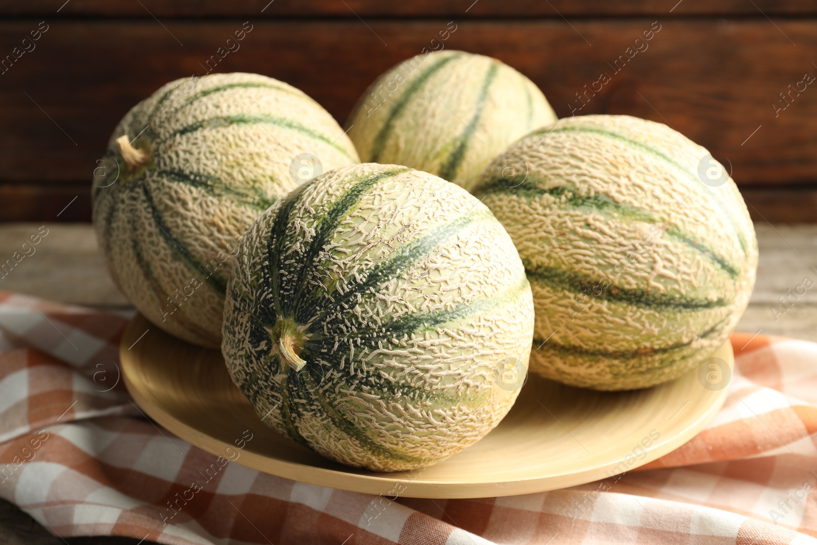 Photo of Tasty ripe Cantaloupe melons on table, closeup