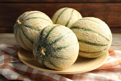 Photo of Tasty ripe Cantaloupe melons on table, closeup