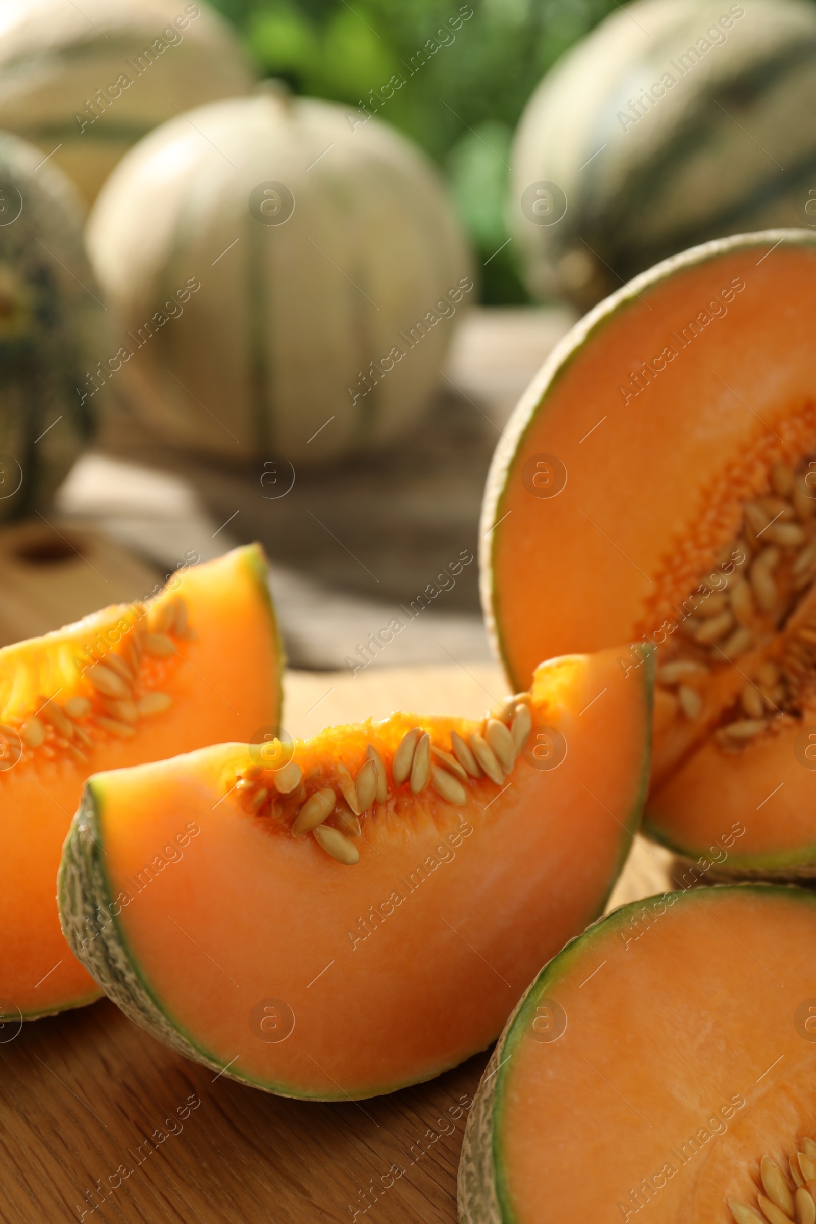 Photo of Cut ripe Cantaloupe melon on table, closeup