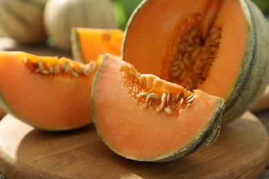 Photo of Cut ripe Cantaloupe melon on table, closeup