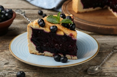 Photo of Slice of homemade blueberry pie on wooden table, closeup