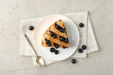 Photo of Slice of delicious homemade blueberry pie served on light table, flat lay