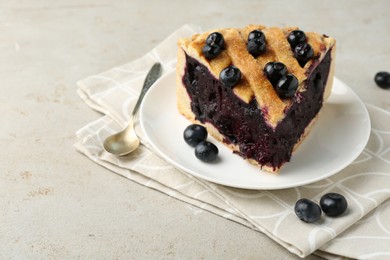 Photo of Slice of delicious homemade blueberry pie served on light table