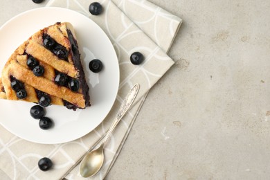 Photo of Slice of delicious homemade blueberry pie served on light table, flat lay. Space for text