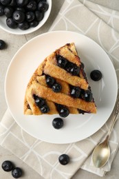 Photo of Slice of delicious homemade blueberry pie served on light table, flat lay