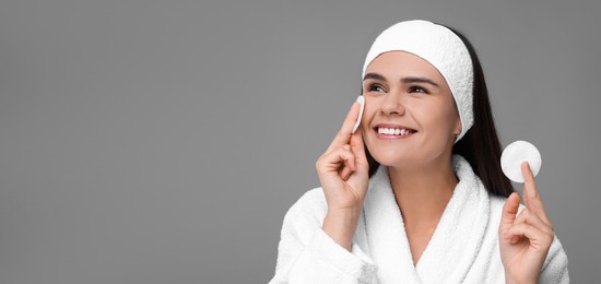 Image of Young woman with cotton pads on grey background. Banner design with space for text