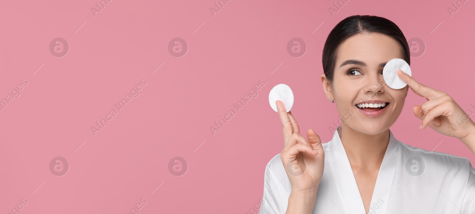 Image of Young woman with cotton pads on pink background. Banner design with space for text